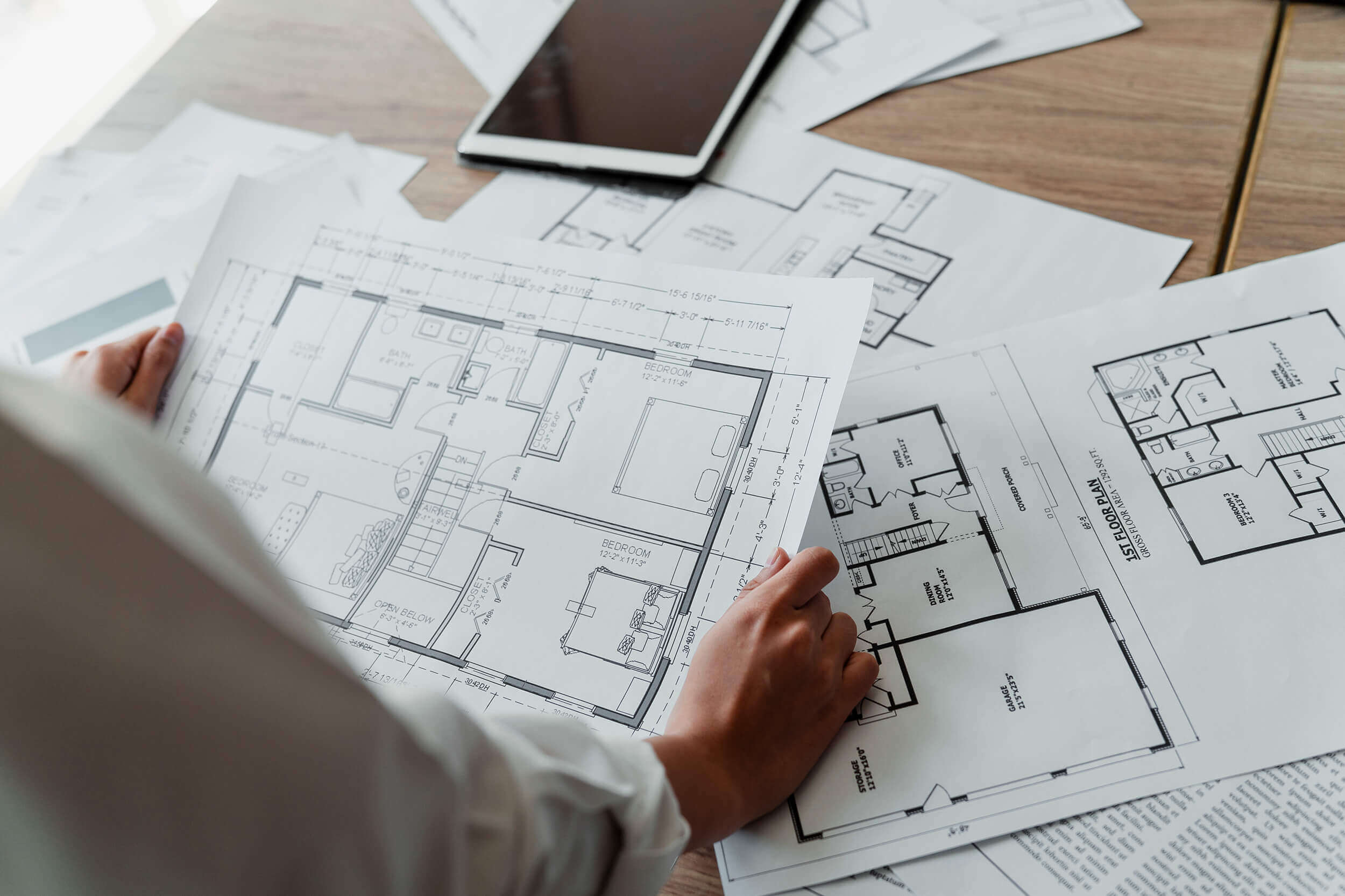 designer-reviewing-construction-plans-aalofts-design Designer Reviewing Construction Plans