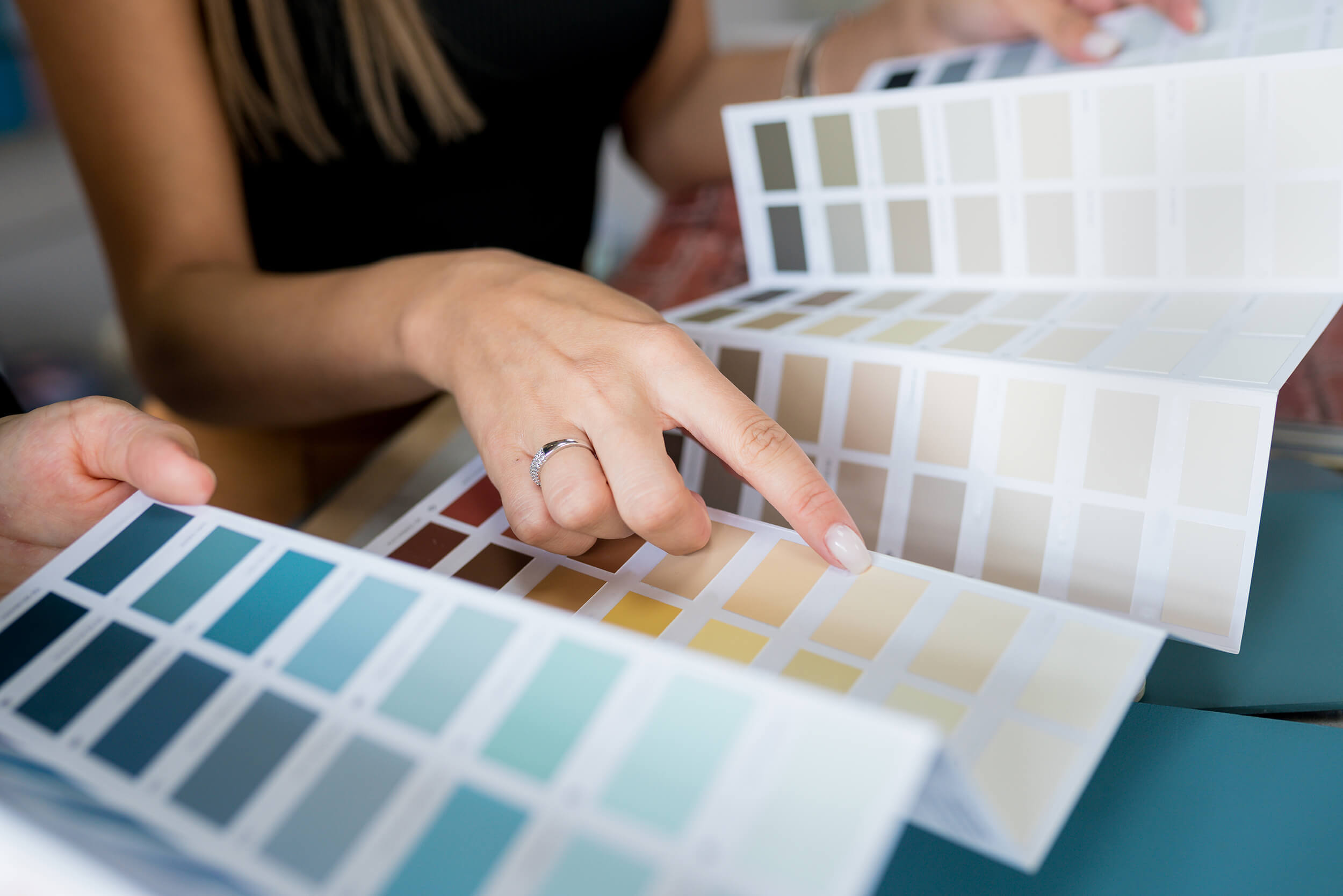 selecting-colour-palette-aalofts-design Woman Selecting Colour Palette in Swatch Book